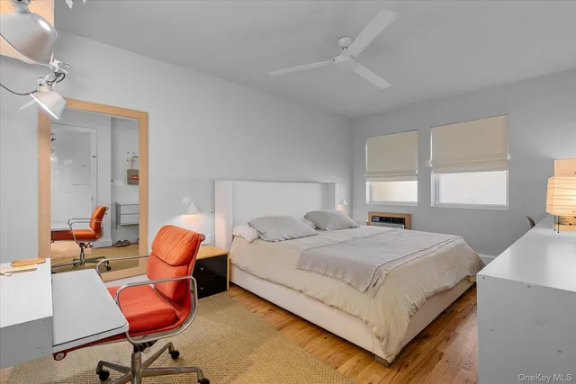 a bedroom with a bed a table and chair