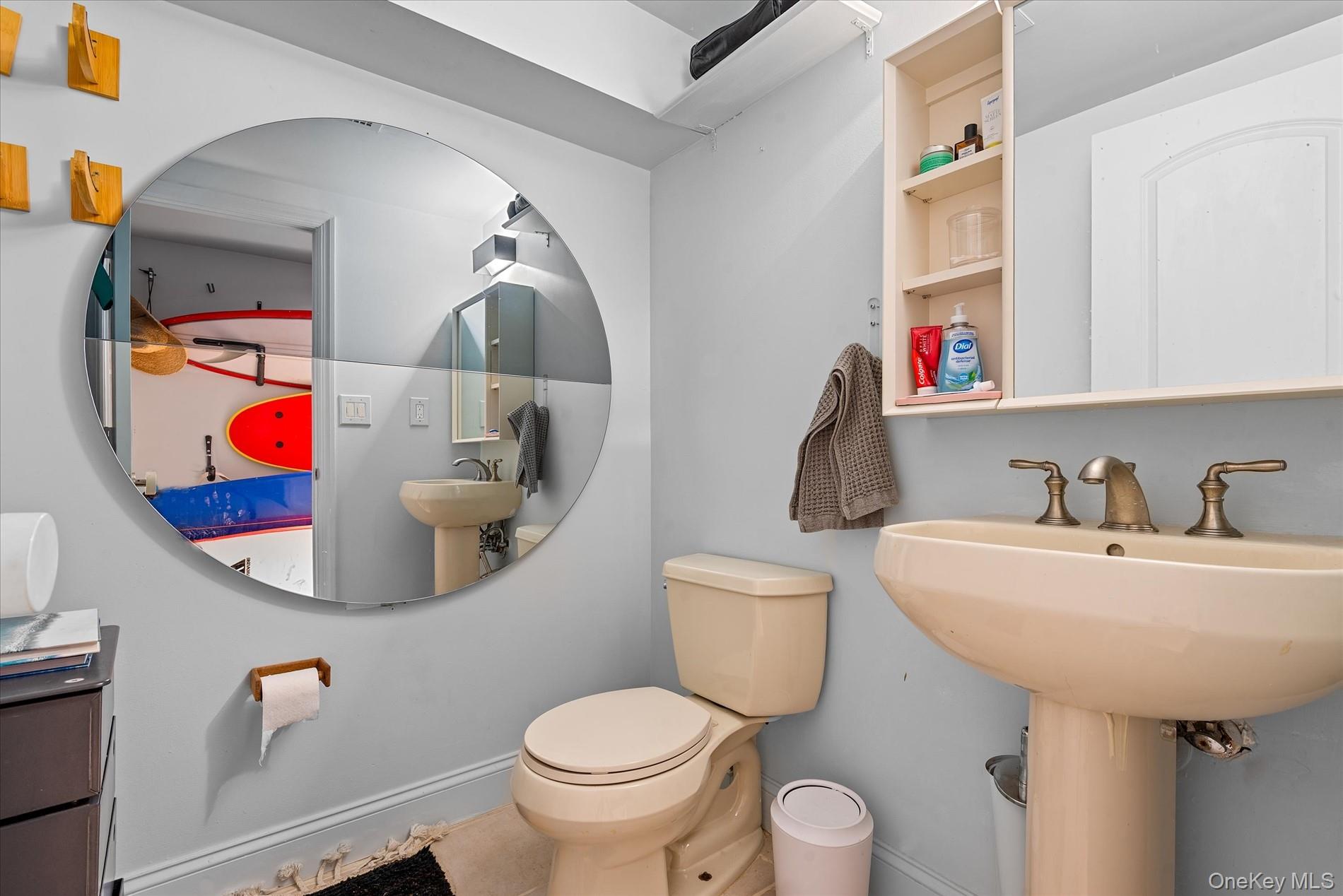 100-12 Shore Front Parkway, Unit 18A Queens, NY 11694 - Photo 29 of 37 a bathroom with a toilet sink and mirror