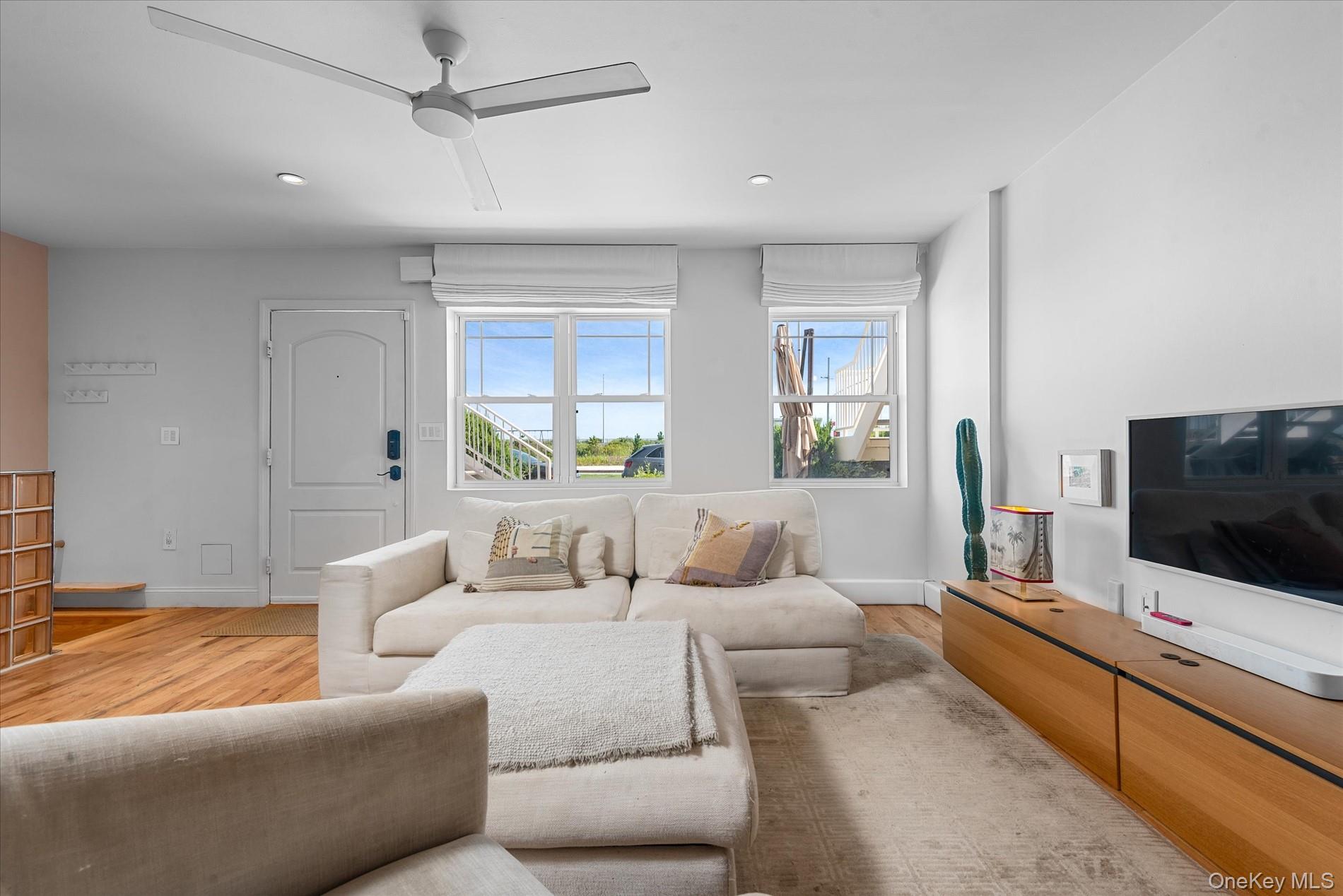 100-12 Shore Front Parkway, Unit 18A Queens, NY 11694 - Photo 9 of 37 a living room with furniture and a flat screen tv