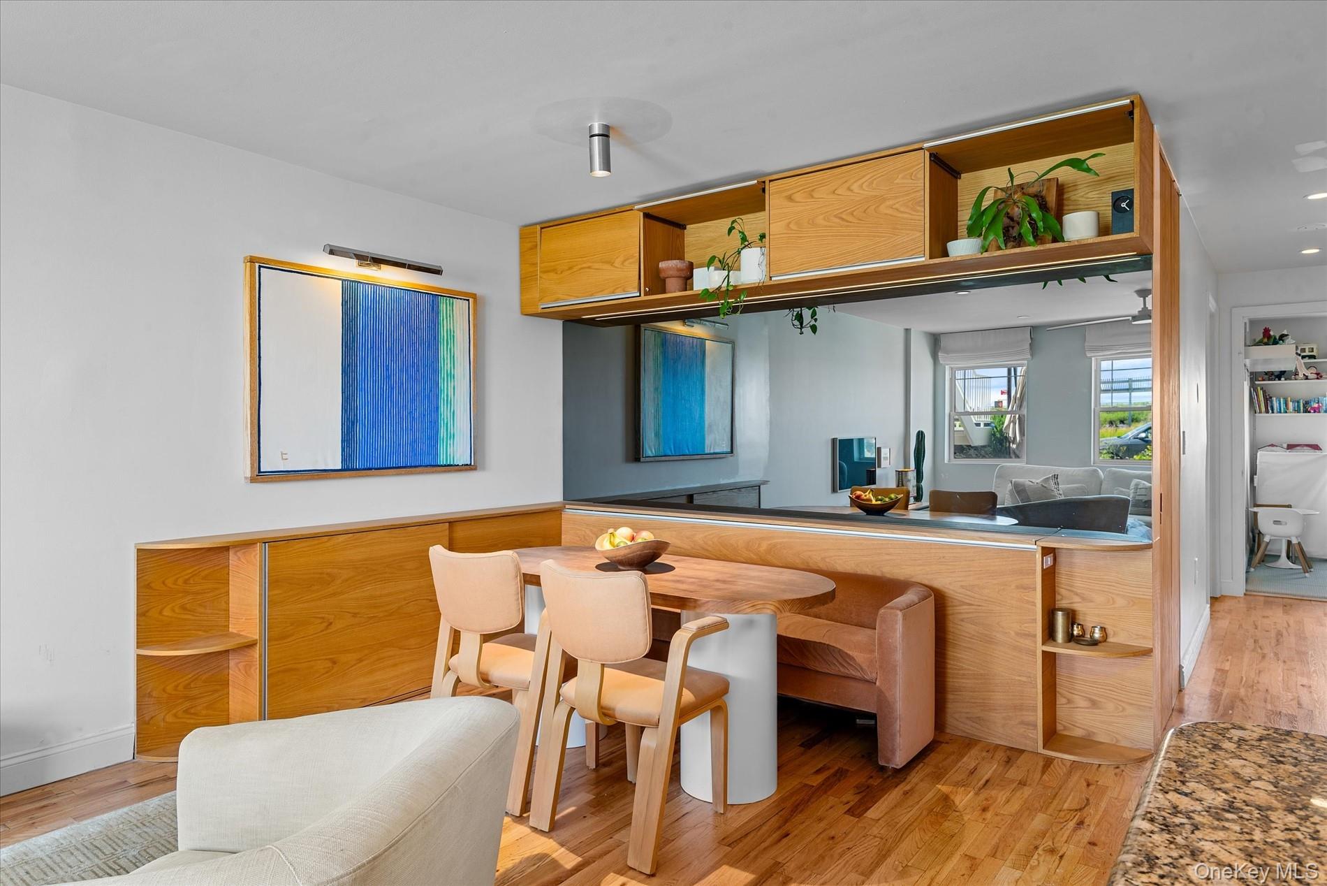 100-12 Shore Front Parkway, Unit 18A Queens, NY 11694 - Photo 10 of 37 a dining room with a table and chairs