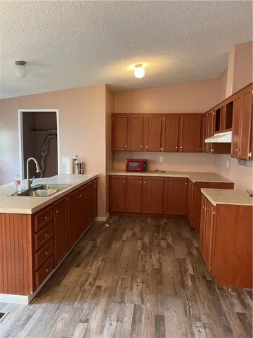 a kitchen with stainless steel appliances granite countertop a sink and cabinets