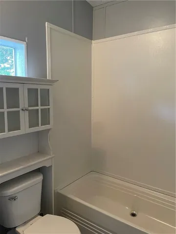 a bathroom with a toilet and a bathtub