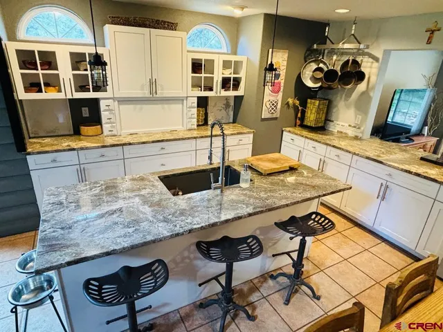 a kitchen with stainless steel appliances granite countertop a sink and a stove