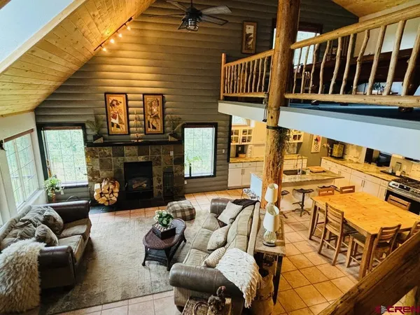 a view of a patio with couches chairs and a fireplace