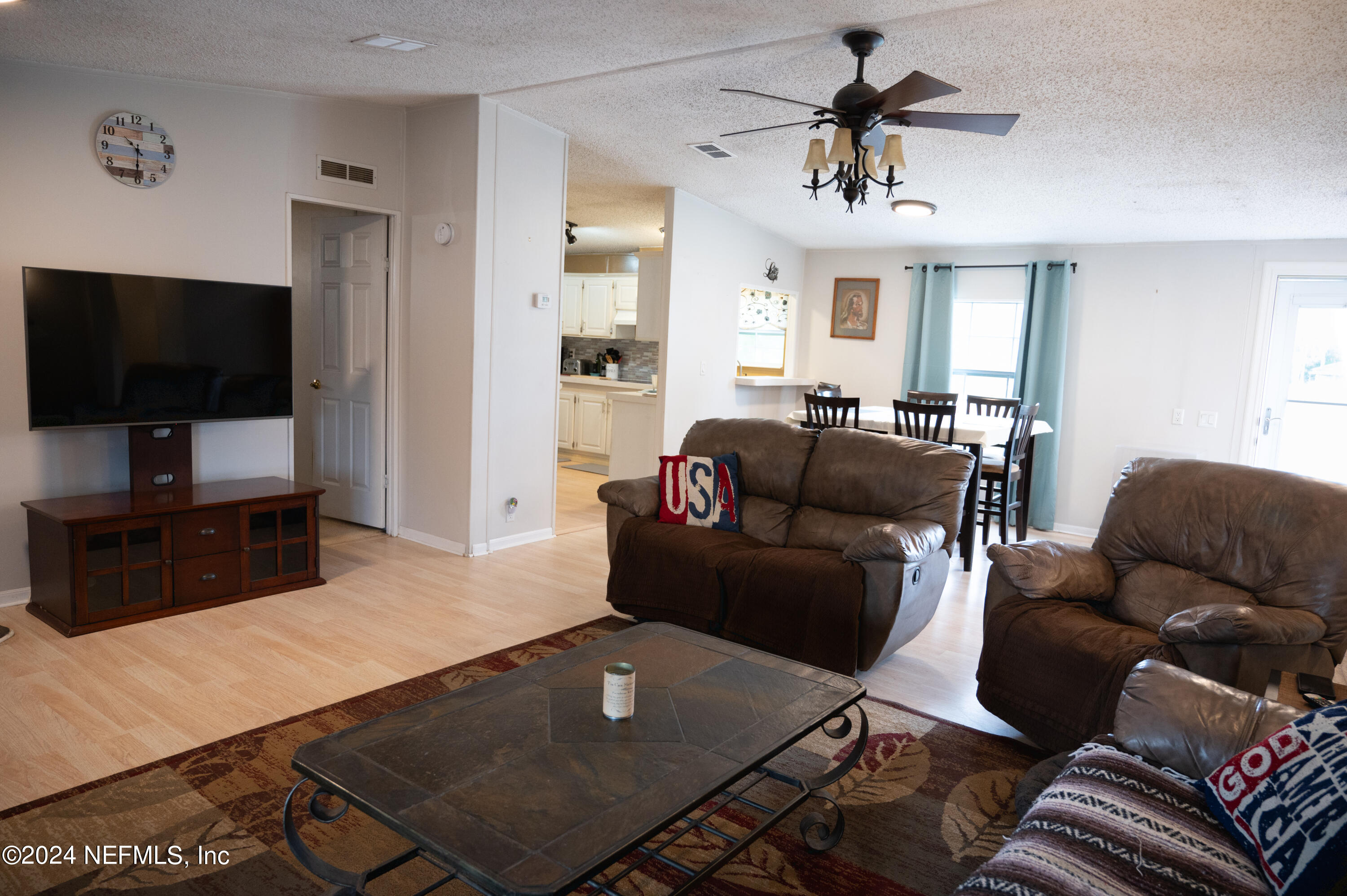 285 Dusty Road St. Augustine, FL 32095 - Photo 11 of 40 a living room with furniture and a flat screen tv