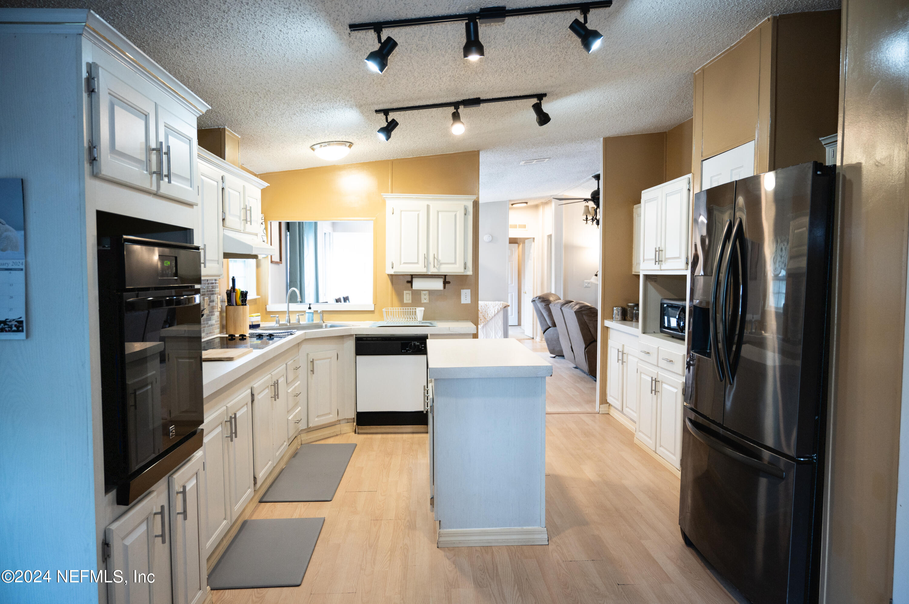 285 Dusty Road St. Augustine, FL 32095 - Photo 14 of 40 a large kitchen with stainless steel appliances refrigerator a microwave and cabinets