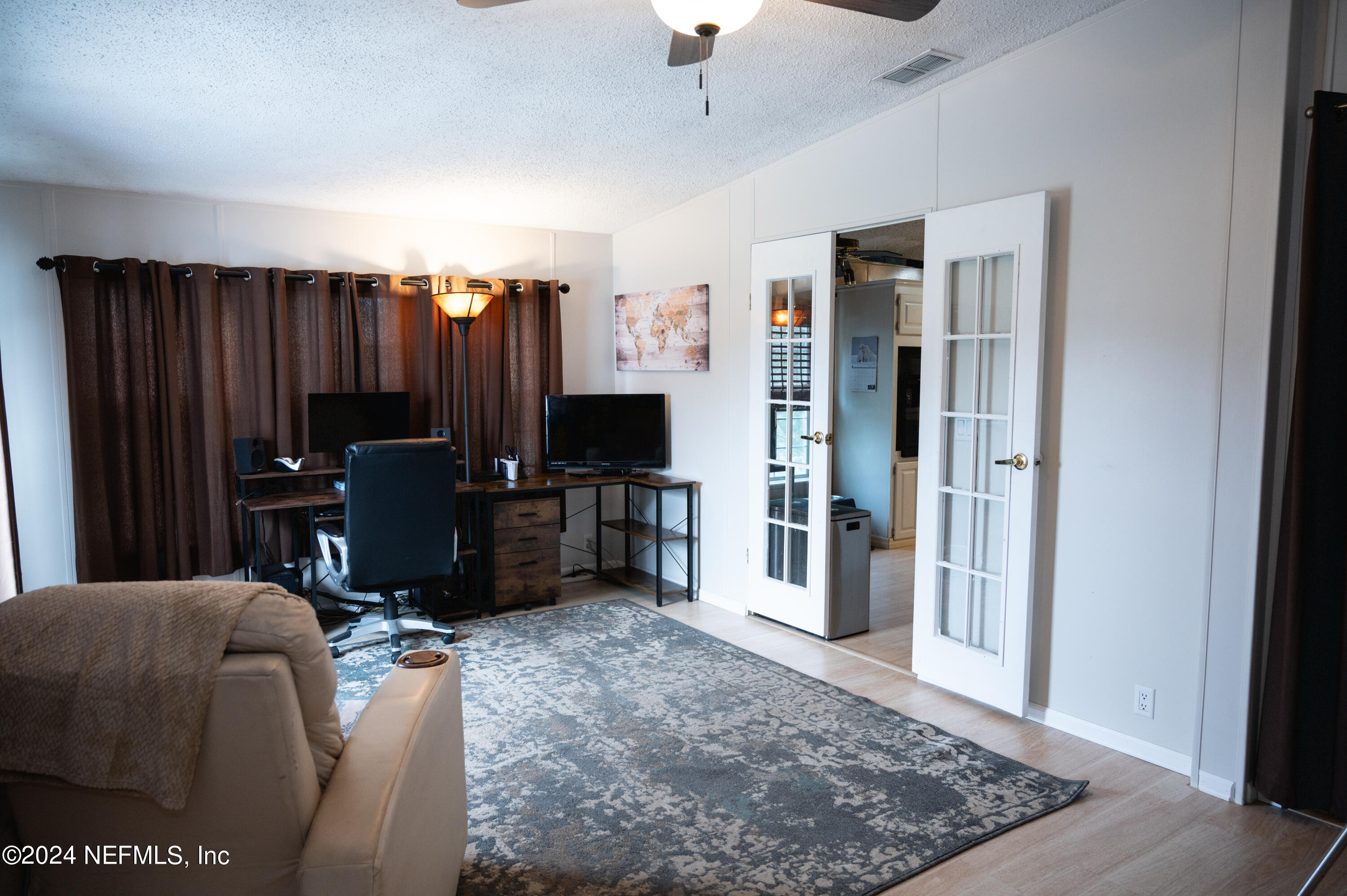 285 Dusty Road St. Augustine, FL 32095 - Photo 17 of 40 a view of a livingroom with furniture and a flat screen tv