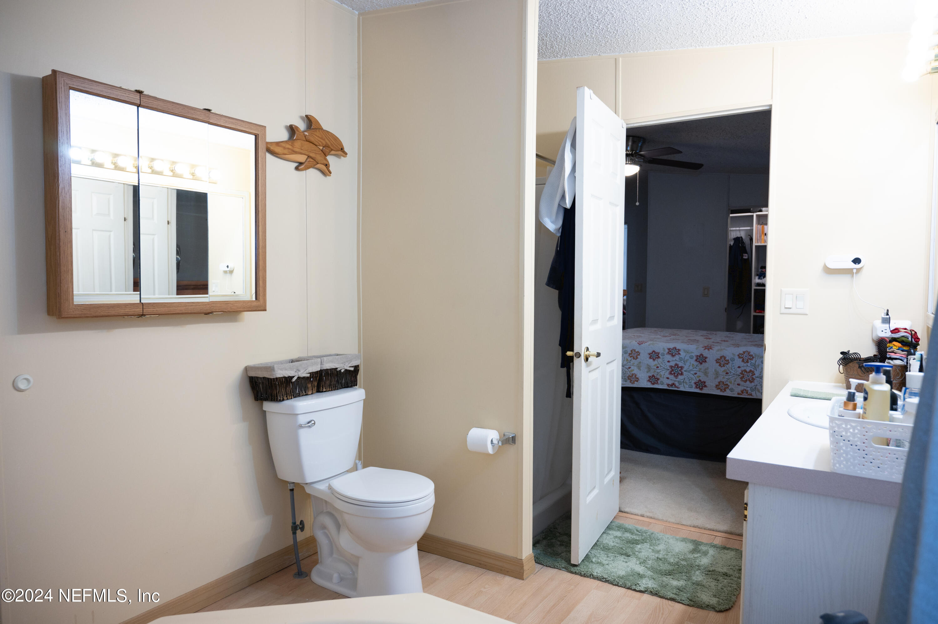 285 Dusty Road St. Augustine, FL 32095 - Photo 19 of 40 a bathroom with a toilet sink and mirror