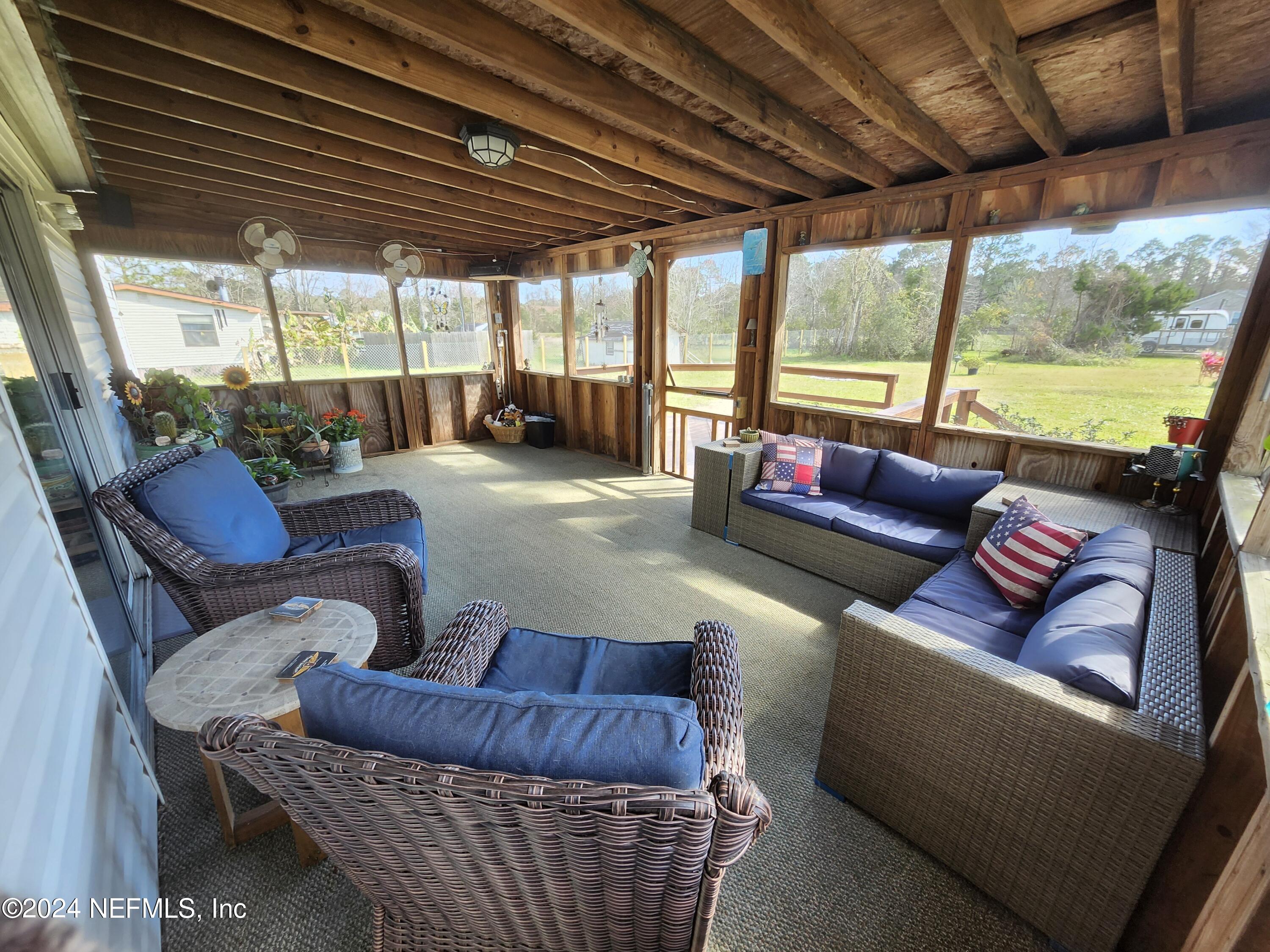 285 Dusty Road St. Augustine, FL 32095 - Photo 2 of 40 a outdoor living space with furniture and a large window