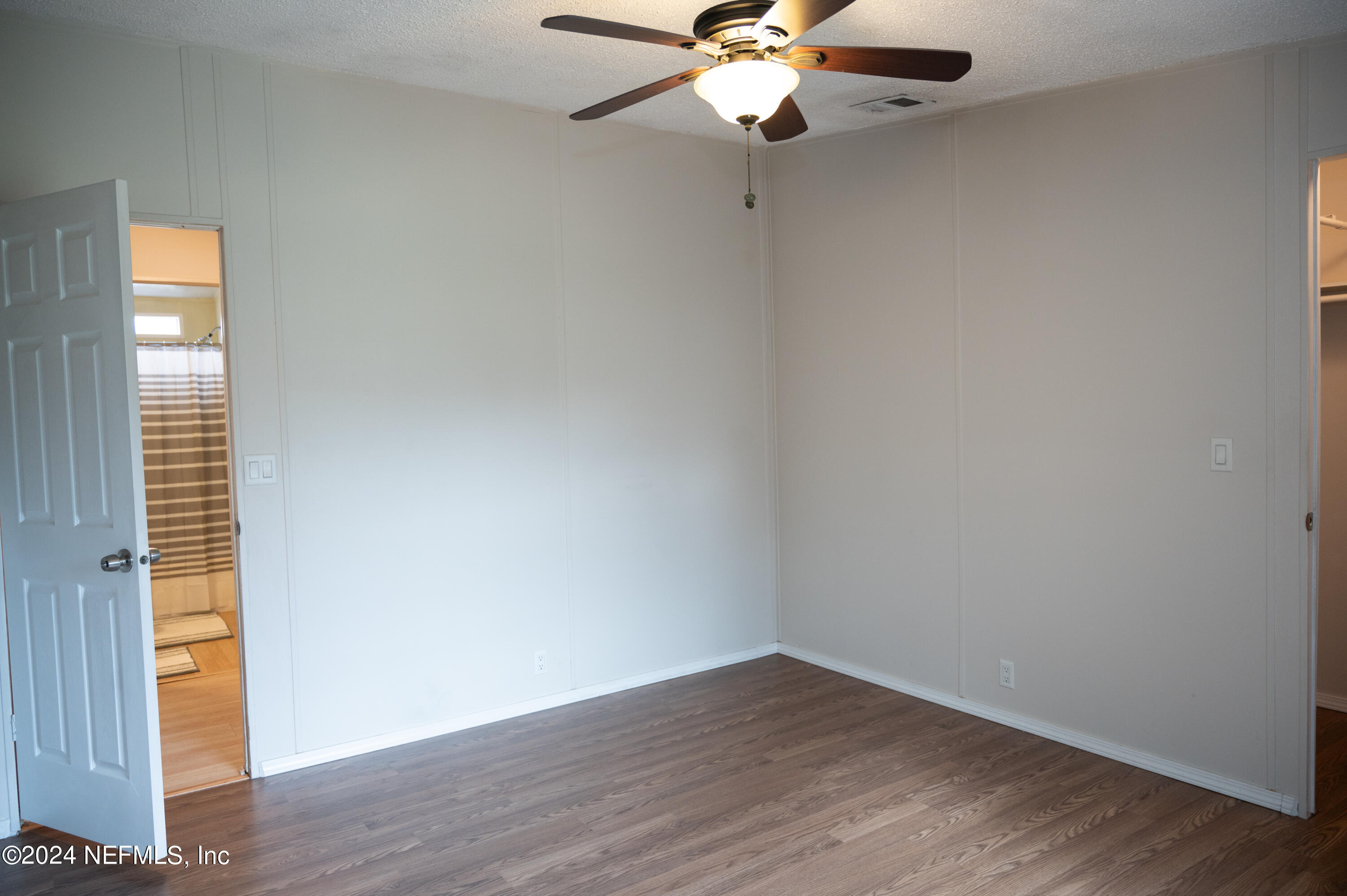 285 Dusty Road St. Augustine, FL 32095 - Photo 23 of 40 an empty room with wooden floor fan and windows