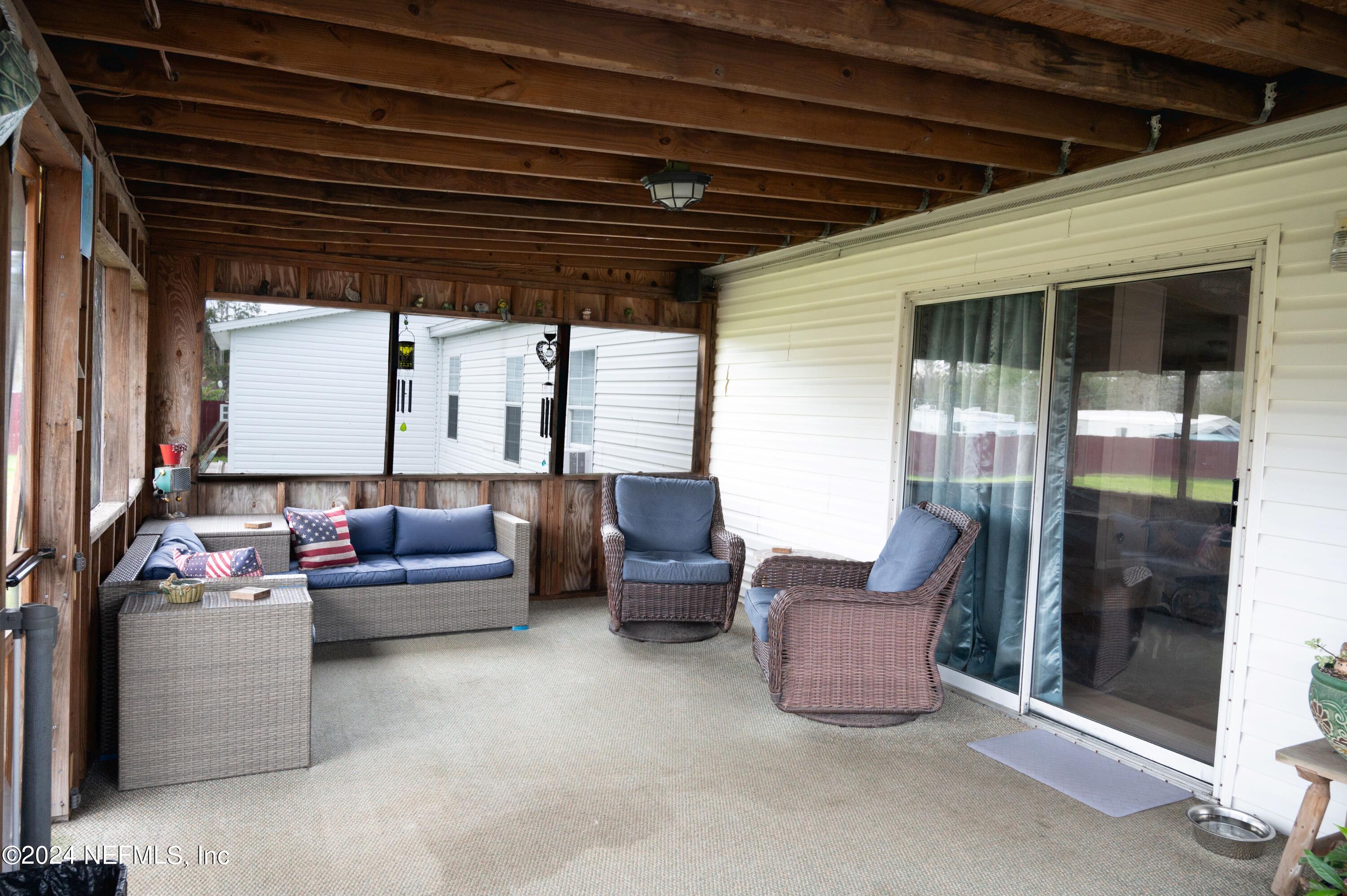 285 Dusty Road St. Augustine, FL 32095 - Photo 27 of 40 a living room with patio furniture and a potted plant