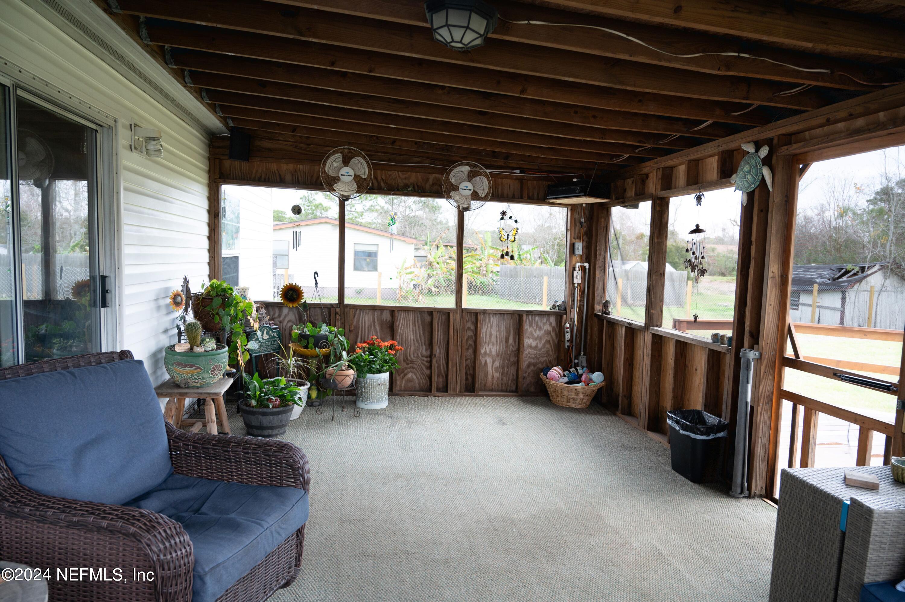 285 Dusty Road St. Augustine, FL 32095 - Photo 28 of 40 a living room with furniture and a potted plant