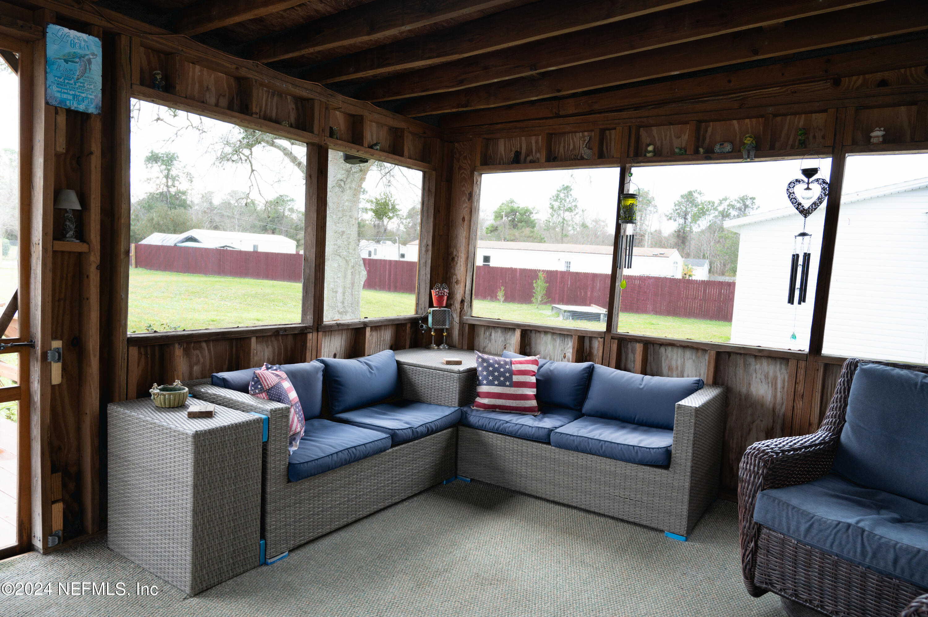 285 Dusty Road St. Augustine, FL 32095 - Photo 30 of 40 a living room with furniture and a floor to ceiling window