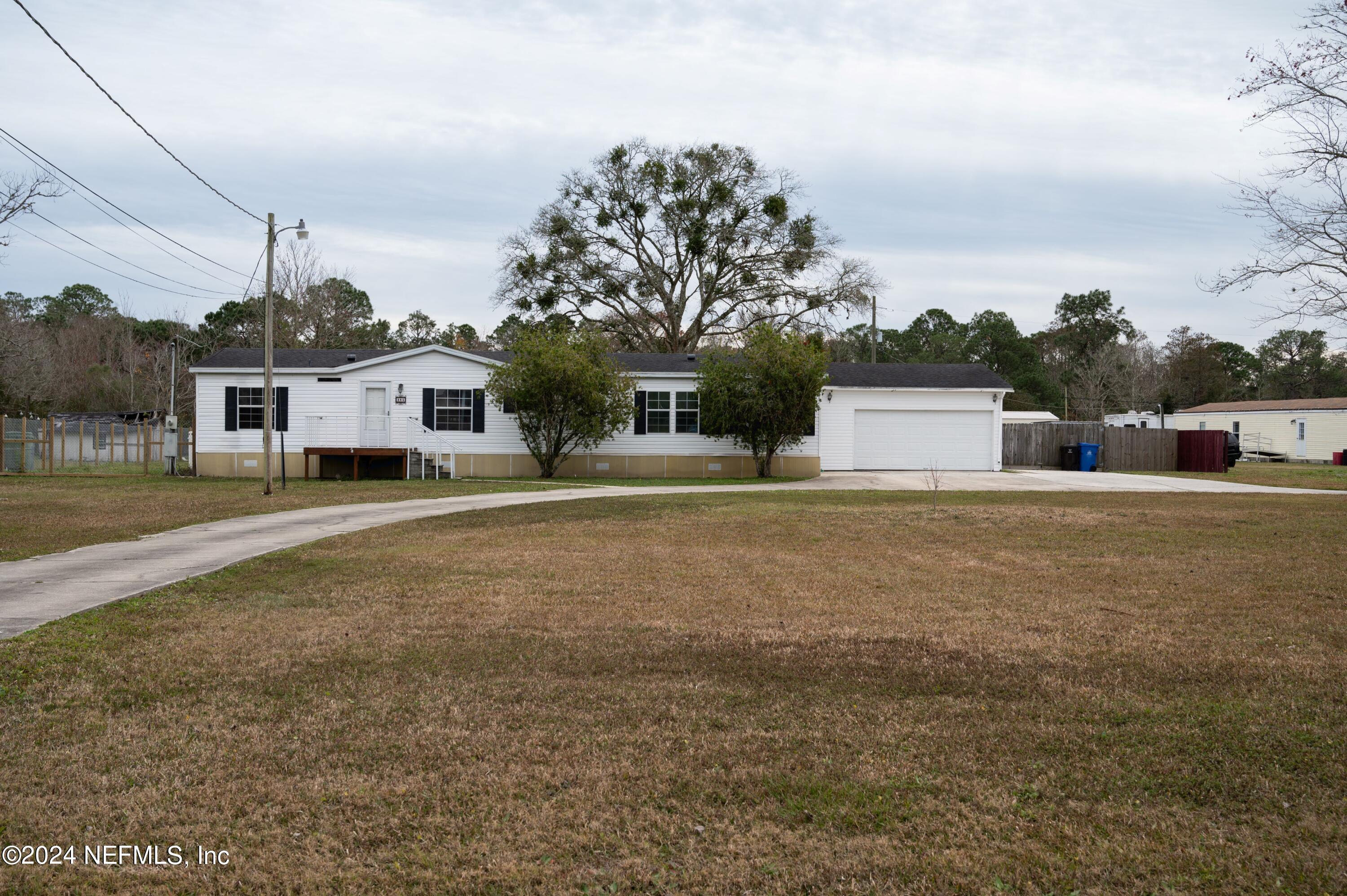 285 Dusty Road St. Augustine, FL 32095 - Photo 3 of 40 a front view of a house with a yard