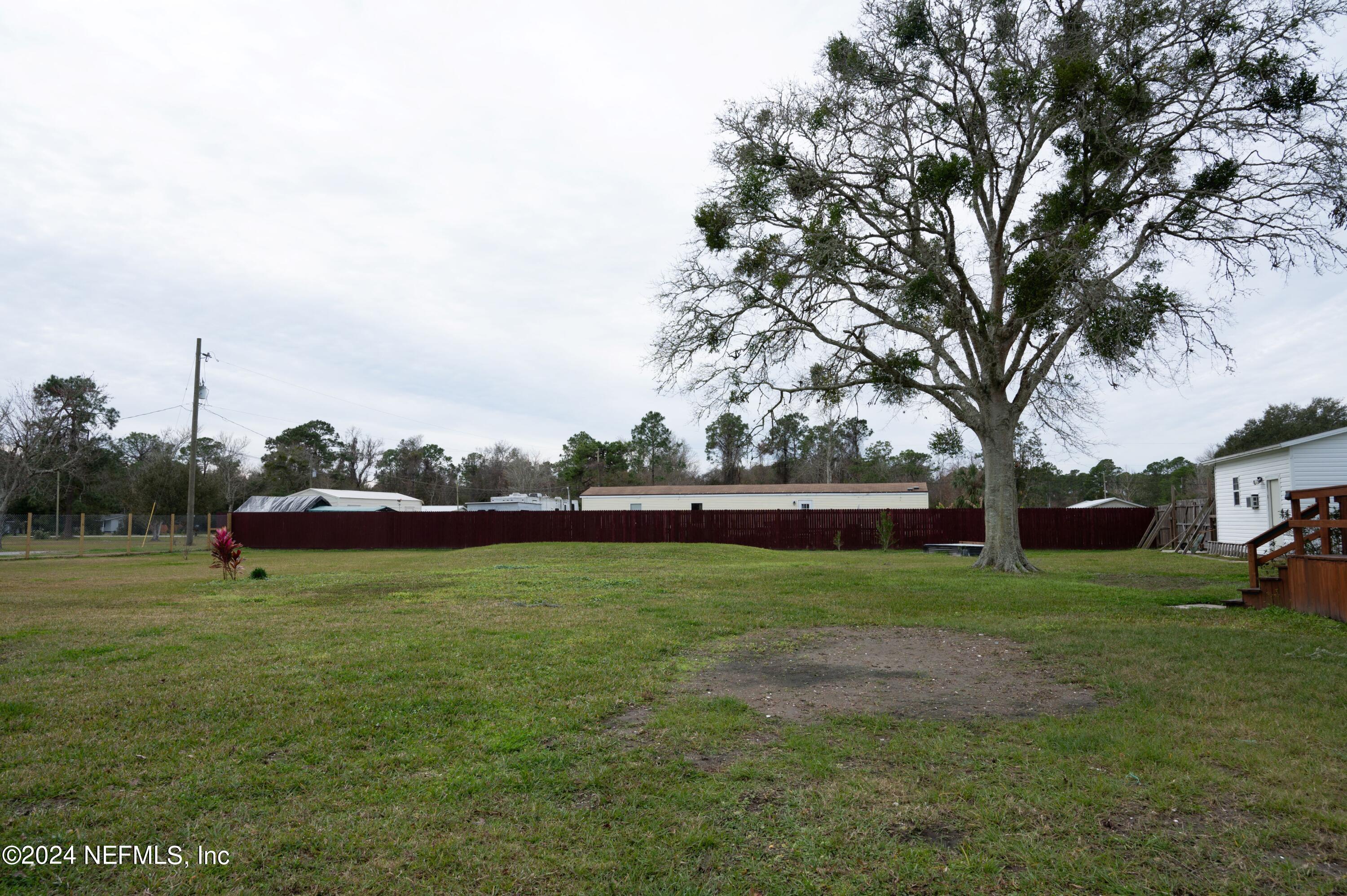 285 Dusty Road St. Augustine, FL 32095 - Photo 33 of 40 a view of a field of grass and trees