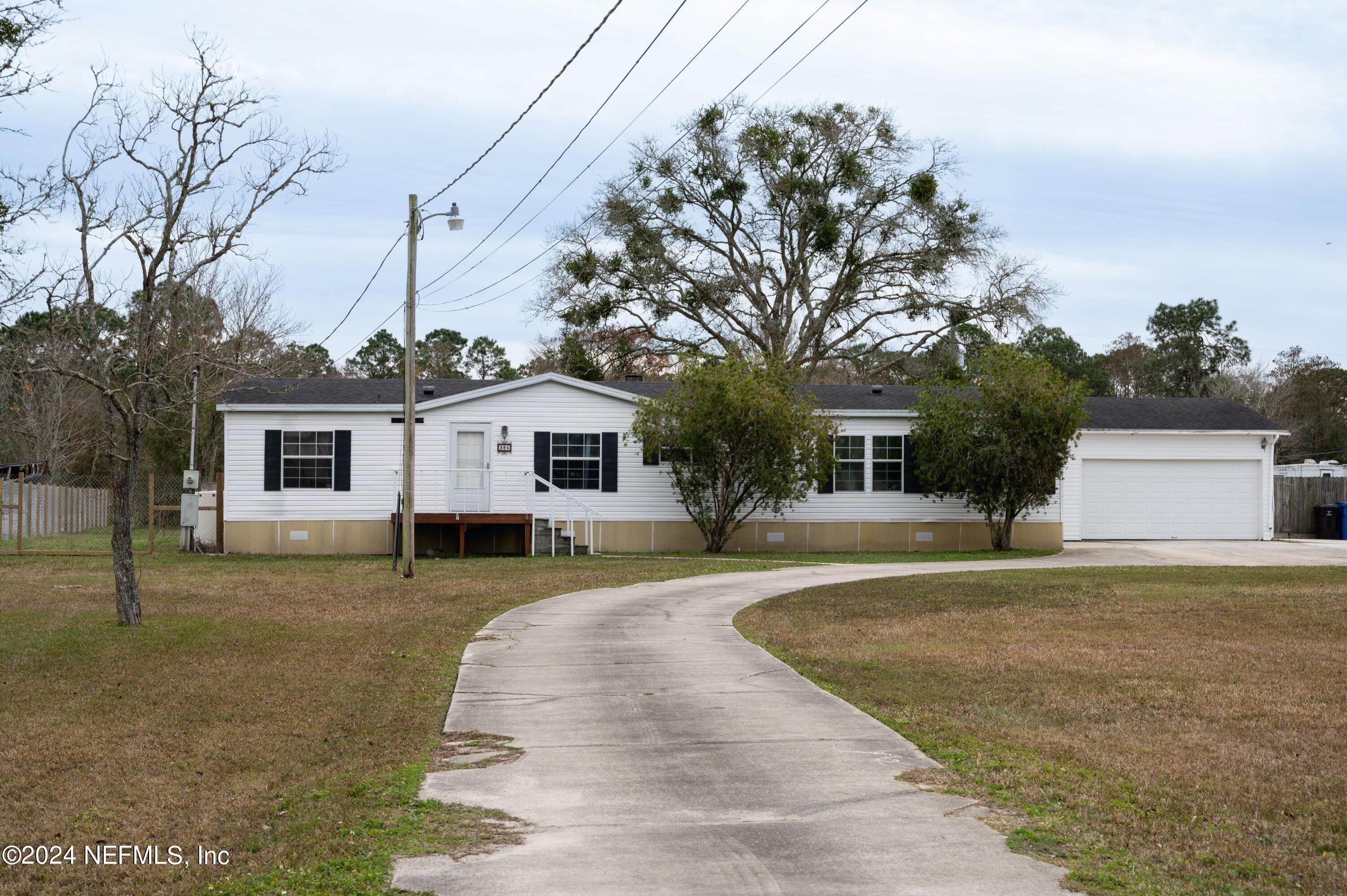 285 Dusty Road St. Augustine, FL 32095 - Photo 4 of 40 a front view of a house with a yard and trees