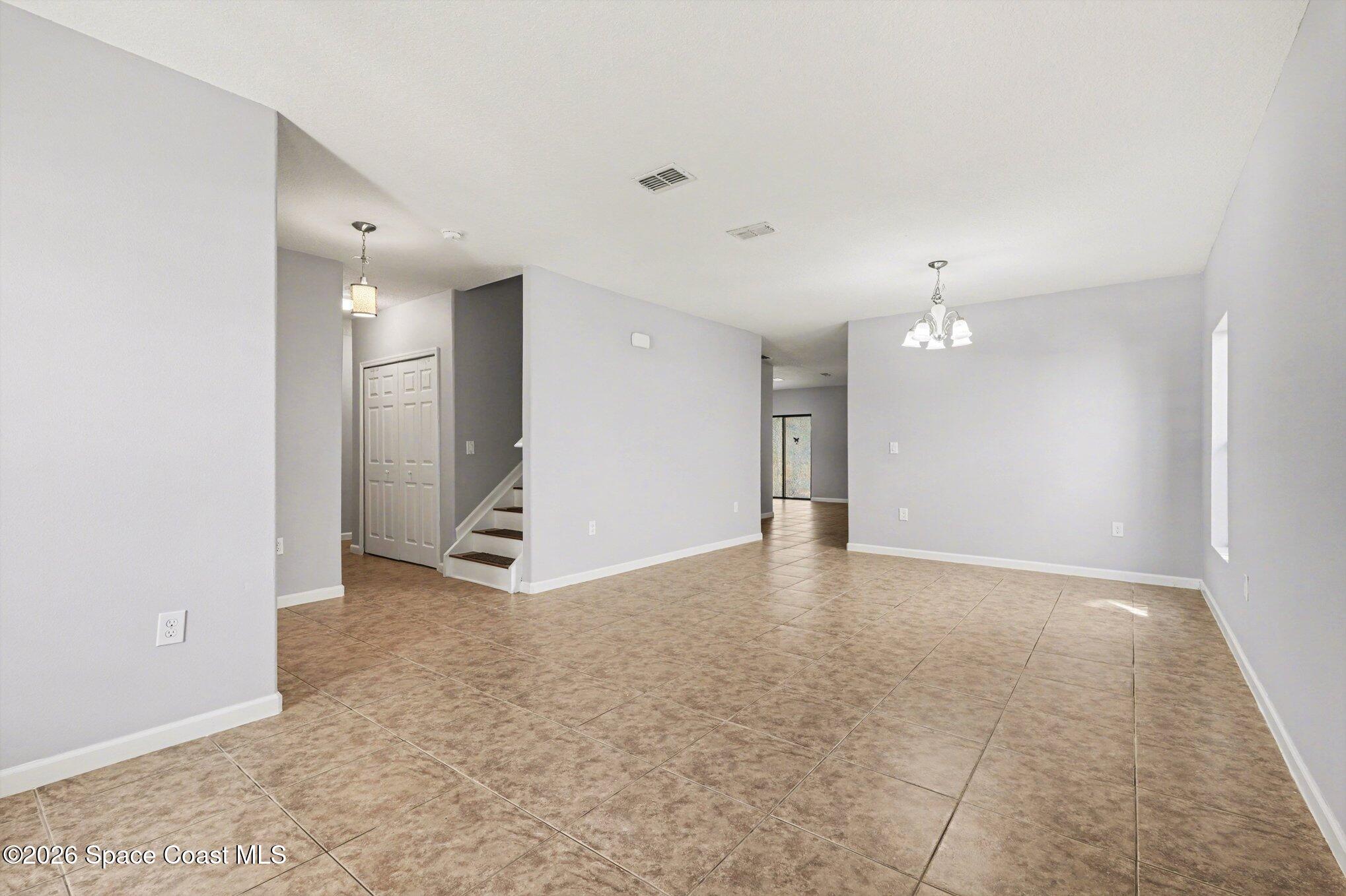 1363 Hailey Street Melbourne, FL 32904 - Photo 11 of 41 an empty room with kitchen view and windows