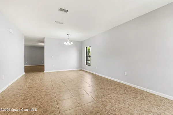 an empty room with windows and entrance