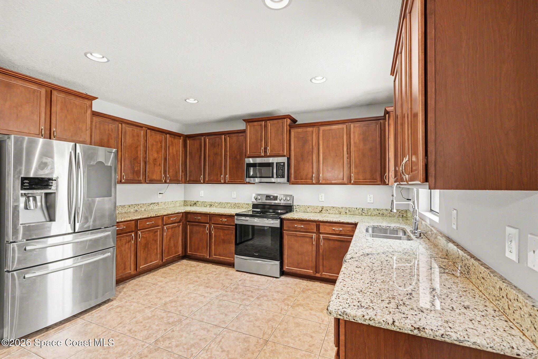 1363 Hailey Street Melbourne, FL 32904 - Photo 15 of 41 a kitchen with stainless steel appliances granite countertop a refrigerator sink and stove