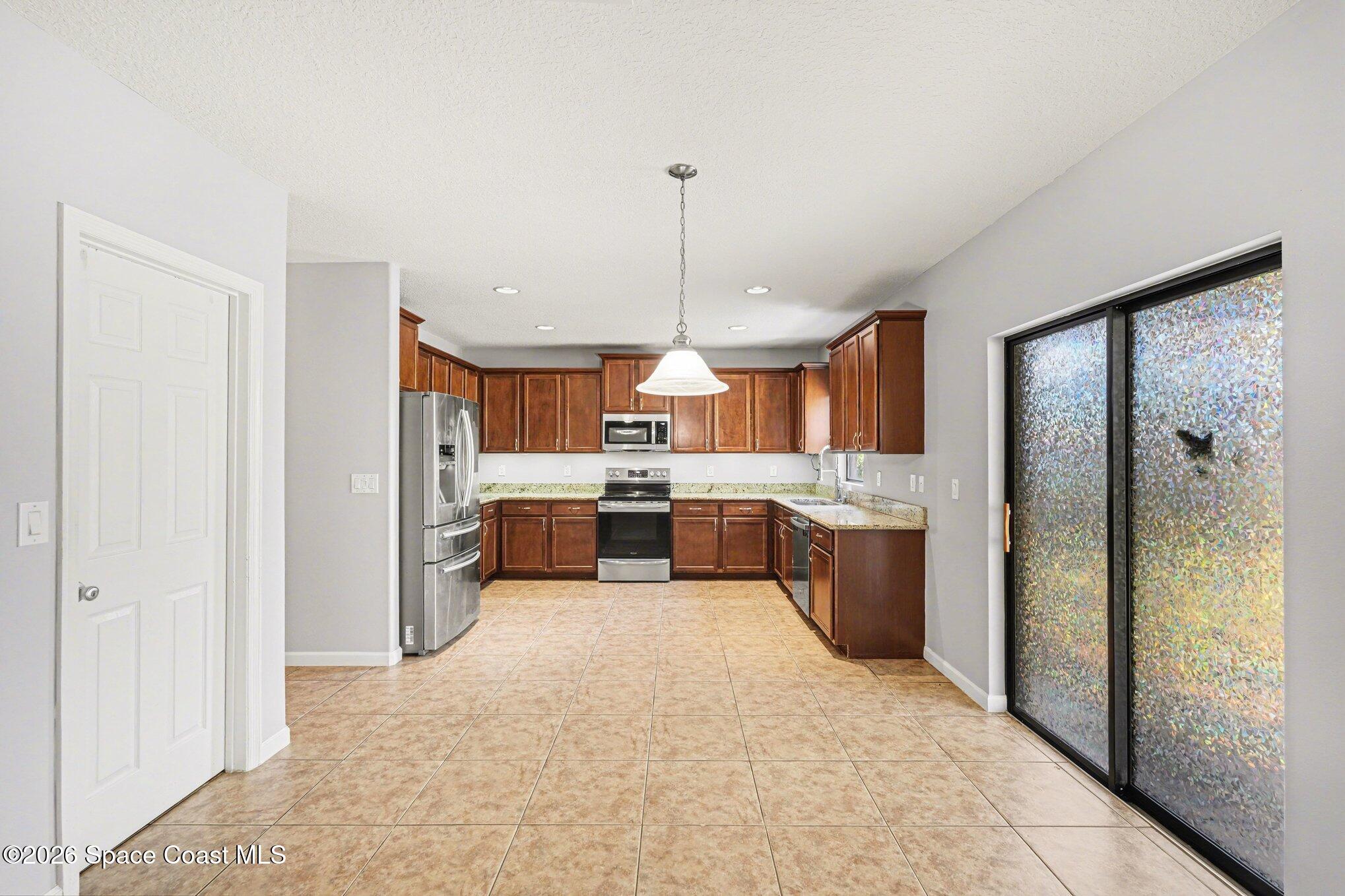1363 Hailey Street Melbourne, FL 32904 - Photo 17 of 41 a large white kitchen with a large window