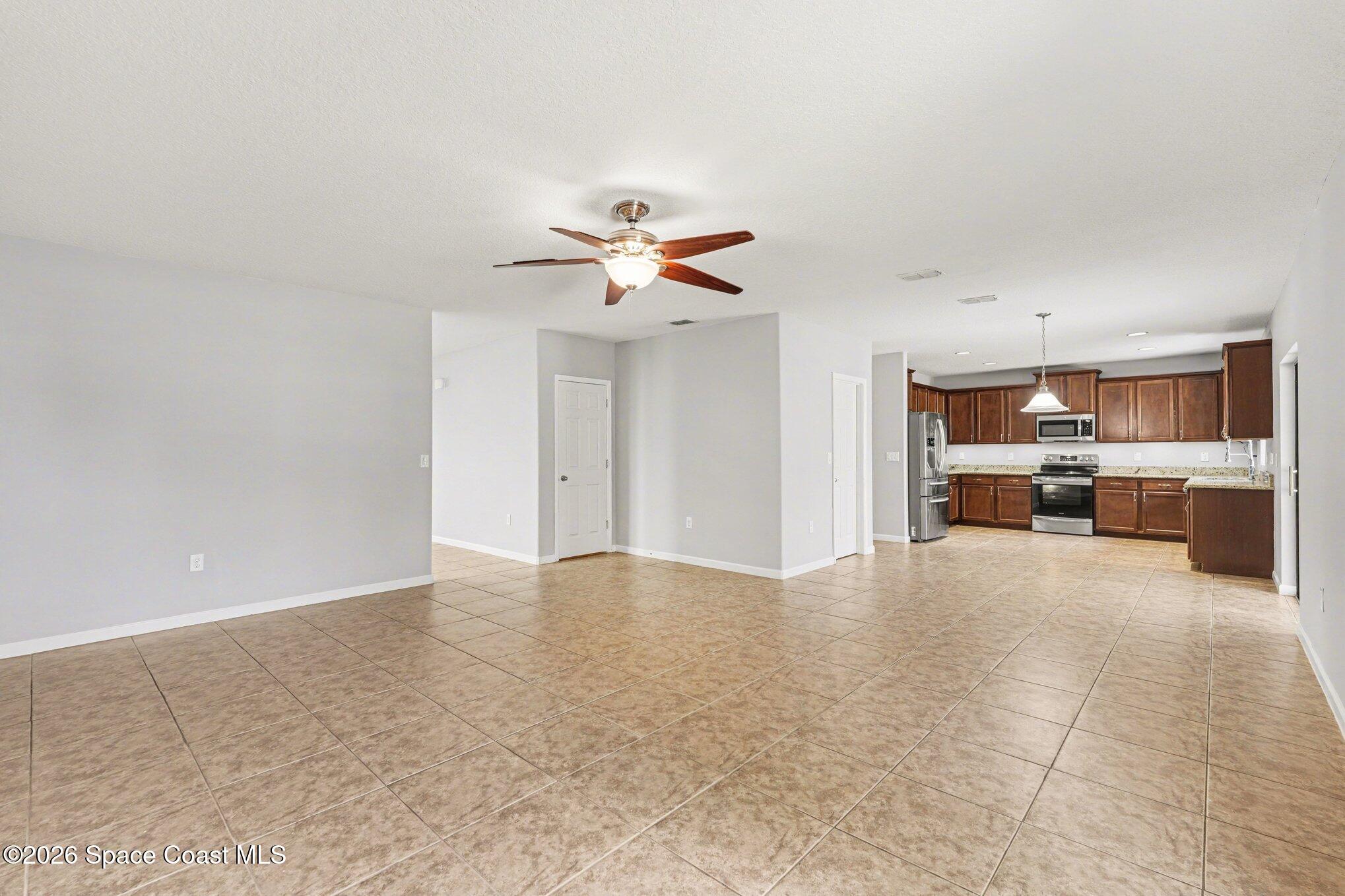 1363 Hailey Street Melbourne, FL 32904 - Photo 19 of 41 a view of an empty room with a kitchen