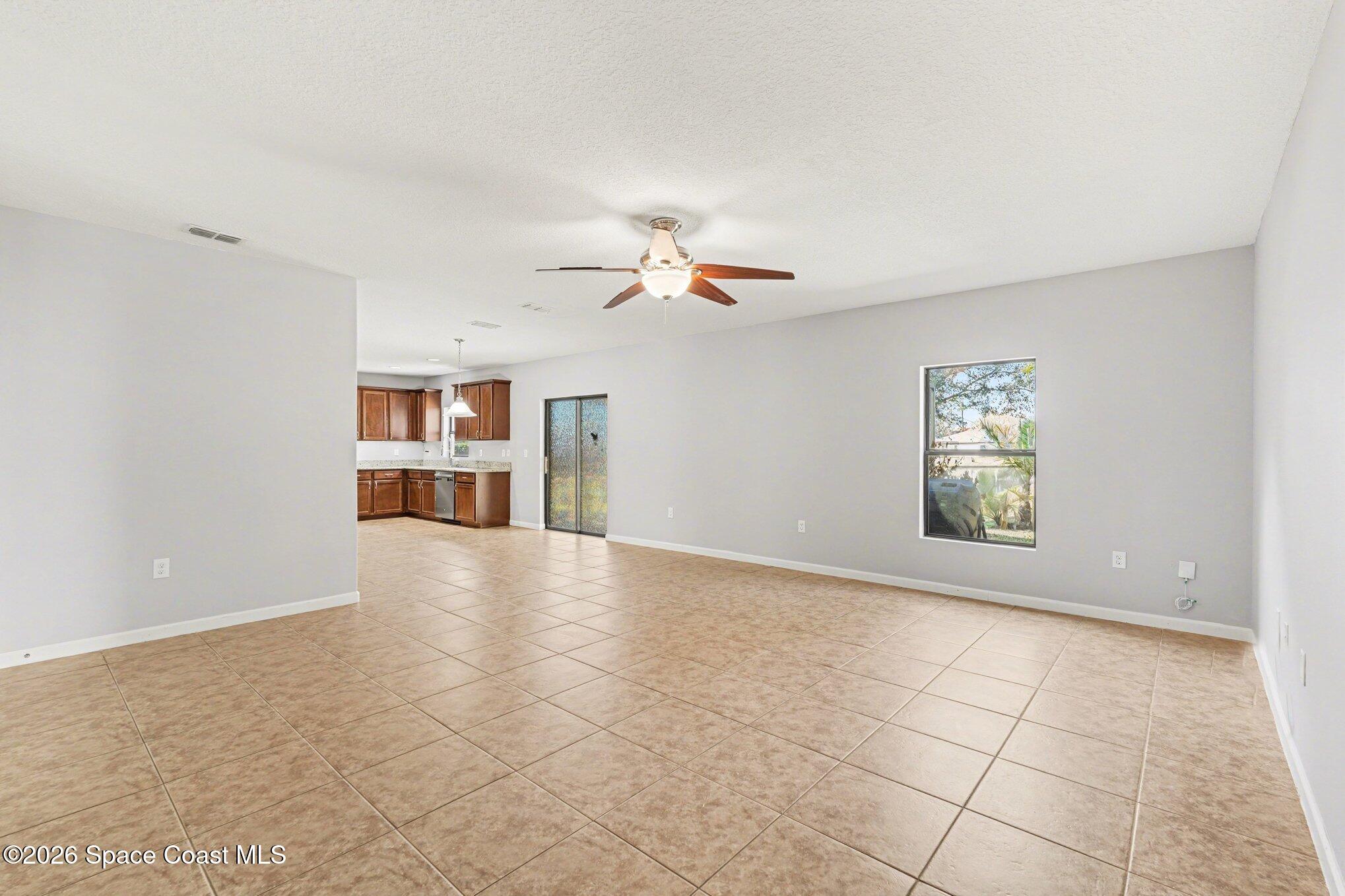 1363 Hailey Street Melbourne, FL 32904 - Photo 20 of 41 wooden floor in an empty room with a window and cabinet