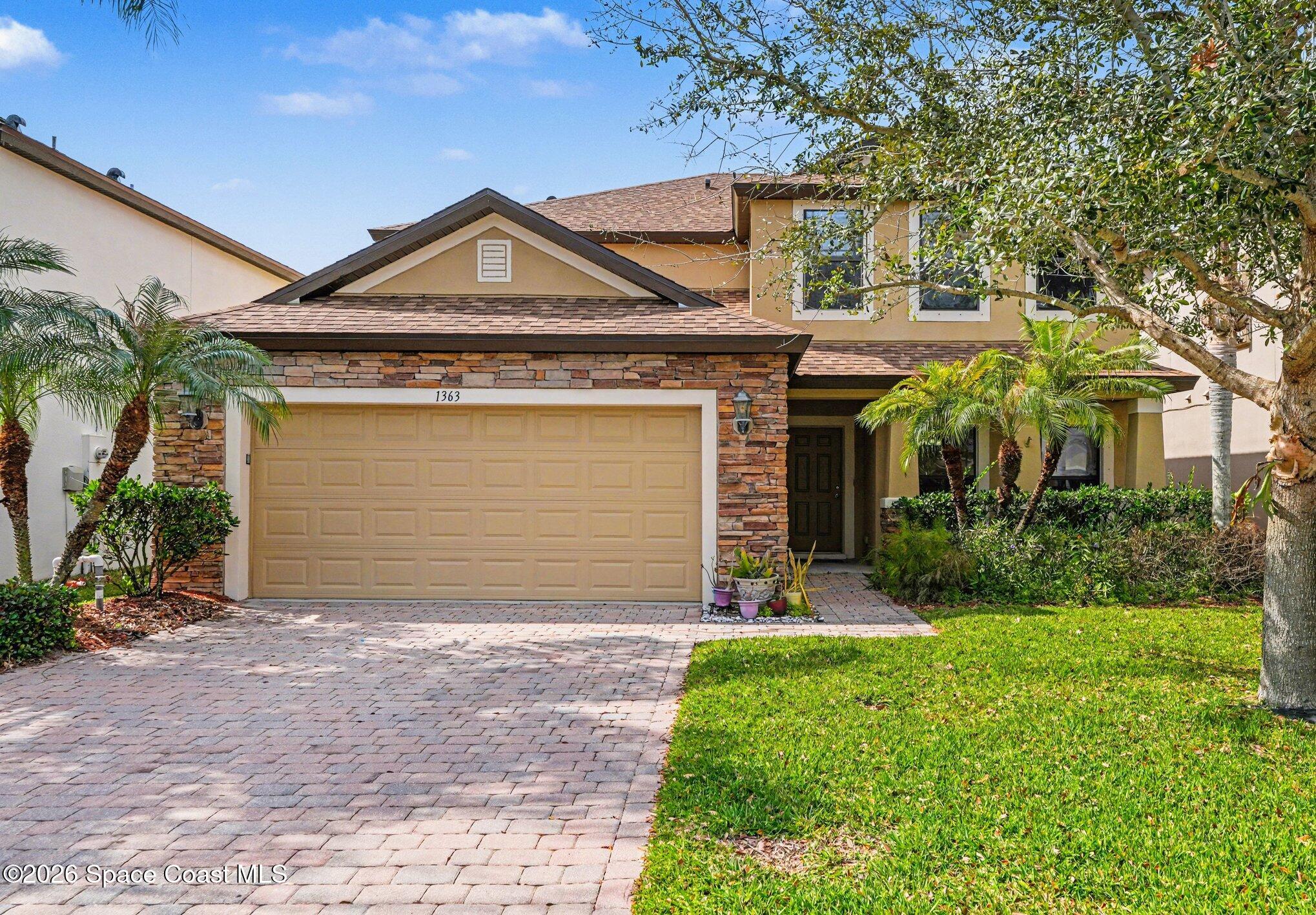 1363 Hailey Street Melbourne, FL 32904 - Photo 2 of 41 a front view of a house with a yard and garage