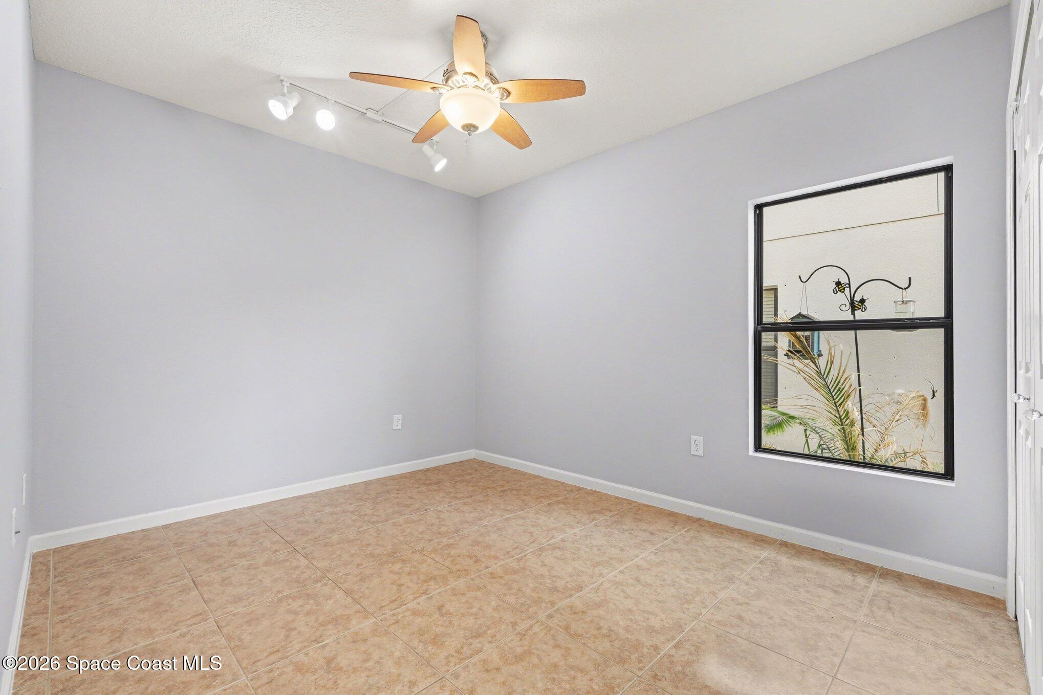 1363 Hailey Street Melbourne, FL 32904 - Photo 24 of 41 an empty room with windows and fan