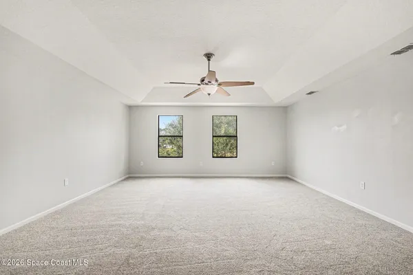 a view of a livingroom with a ceiling fan and window
