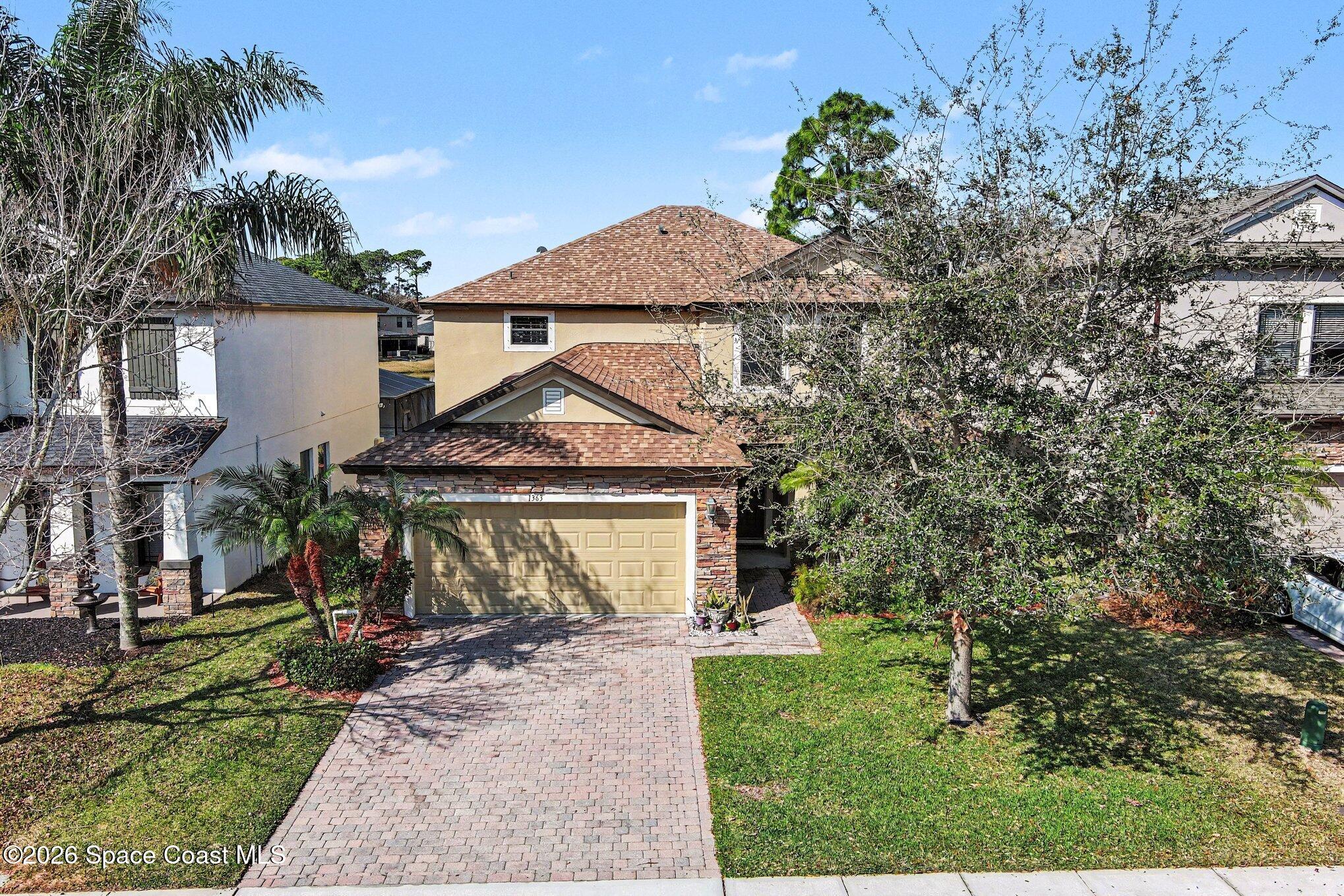 1363 Hailey Street Melbourne, FL 32904 - Photo 3 of 41 a view of a white house with a yard and potted plants