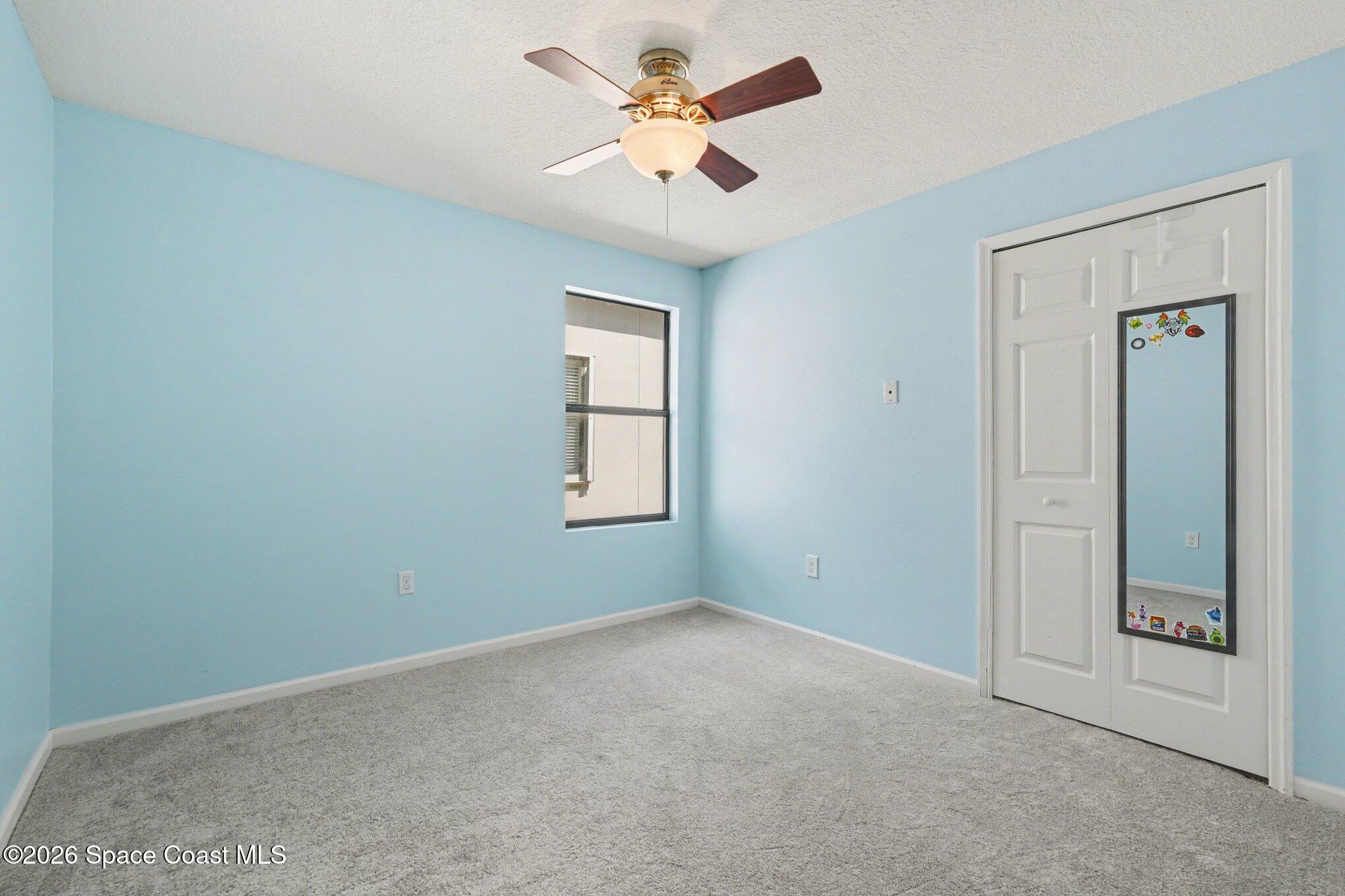 1363 Hailey Street Melbourne, FL 32904 - Photo 37 of 41 an empty room with windows and fan