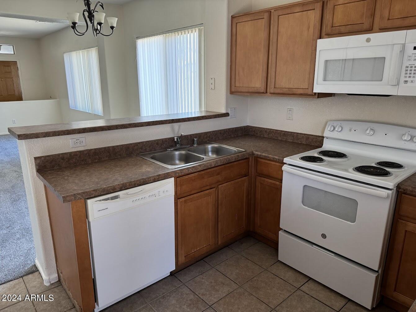 9401 West Berkeley Road Phoenix, AZ 85037 - Photo 6 of 27 a kitchen with a sink stove and cabinets