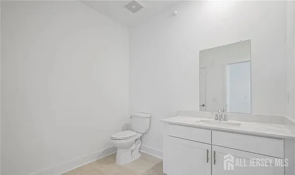 a bathroom with a sink mirror and toilet