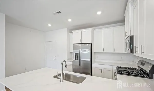 a kitchen with stainless steel appliances a refrigerator and a stove