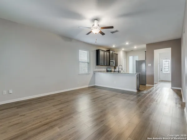 a view of a kitchen with a sink a microwave and floor to ceiling window
