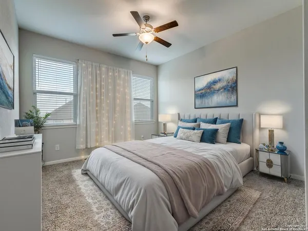 a bedroom with a bed and a large window