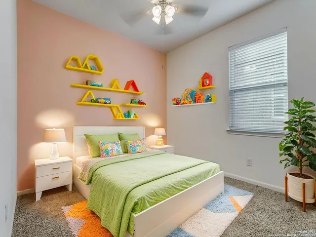 a bedroom with a bed and a potted plant