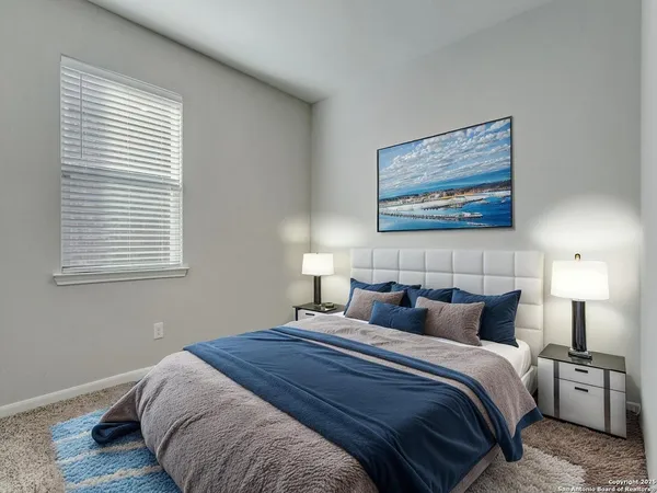 a bedroom with bed and window