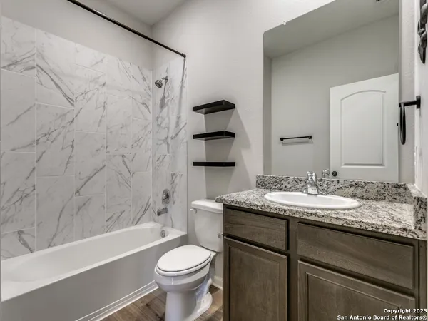 a bathroom with a sink a toilet and bathtub