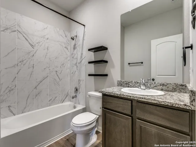 a bathroom with a sink a toilet and bathtub