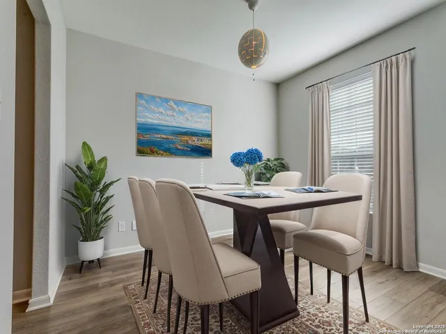 a view of a dining room with furniture window and wooden floor