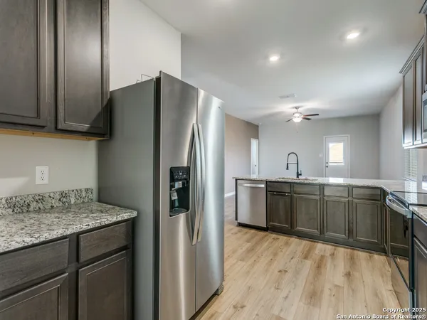 a kitchen with a sink refrigerator and microwave