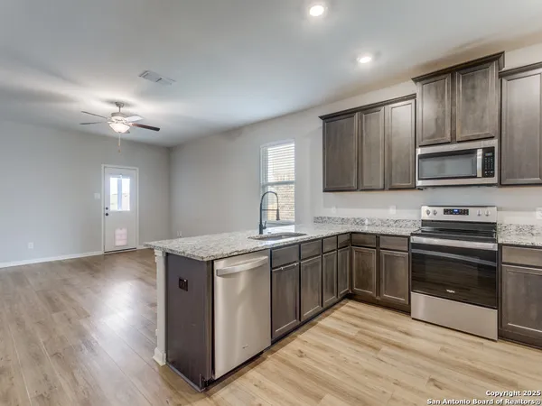 a kitchen with stainless steel appliances granite countertop a stove and a sink