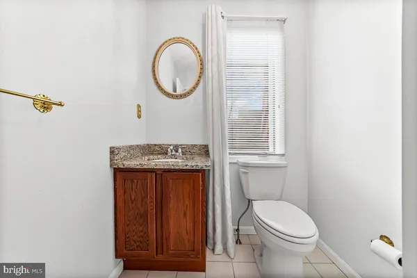 a bathroom with a toilet a sink and a mirror