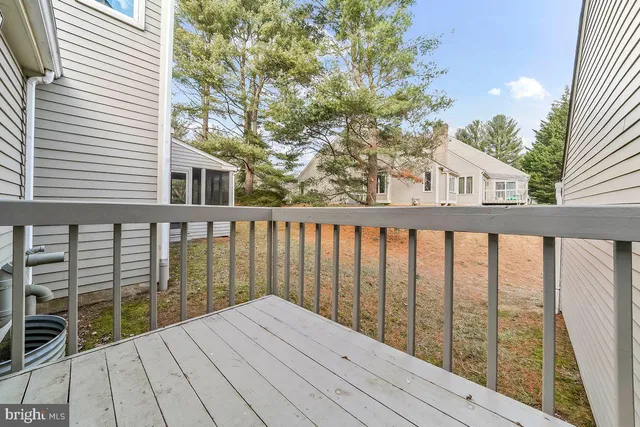 a view of backyard with a deck and wooden floor