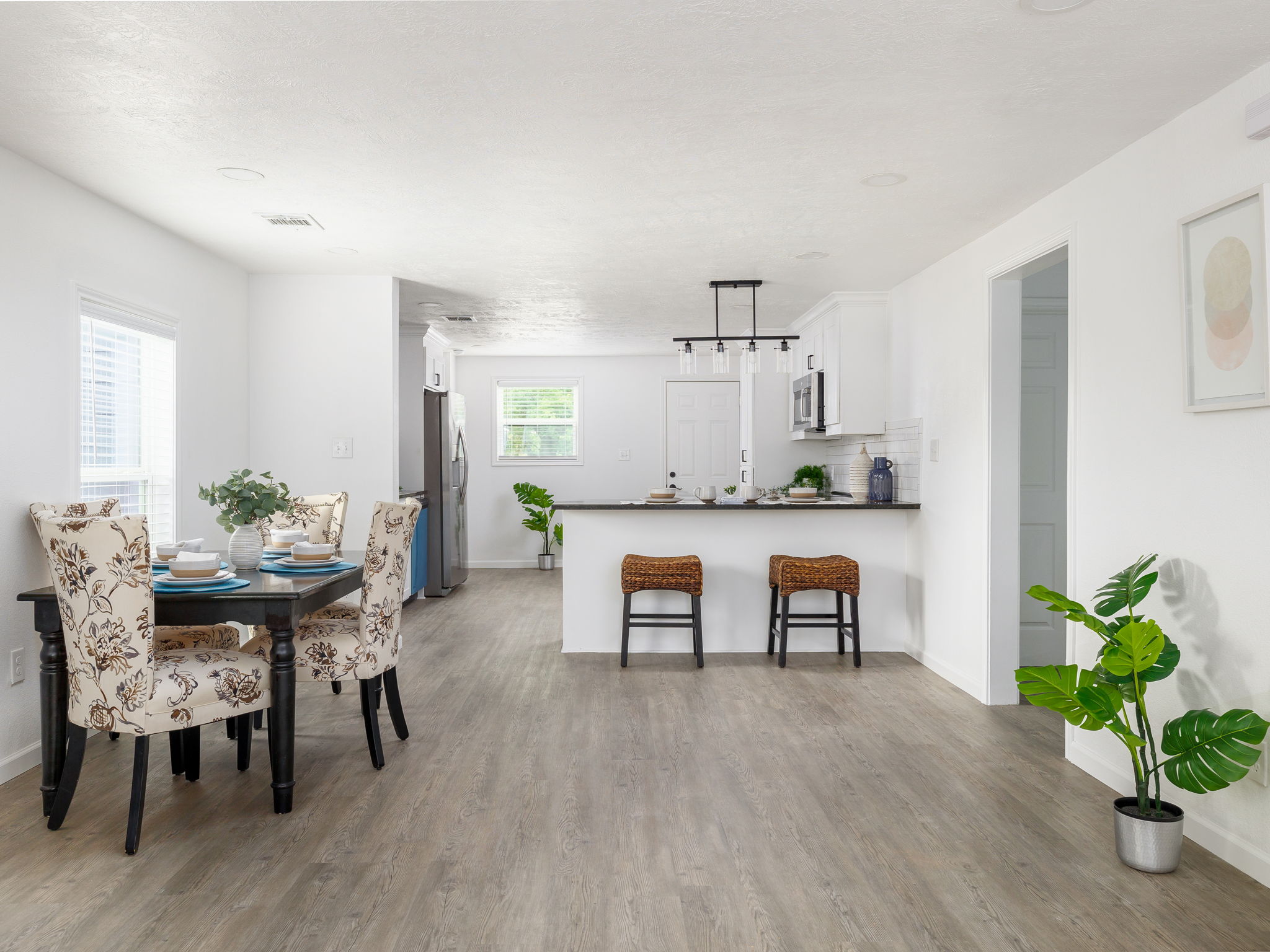 a view of a dining room with furniture and wooden floor