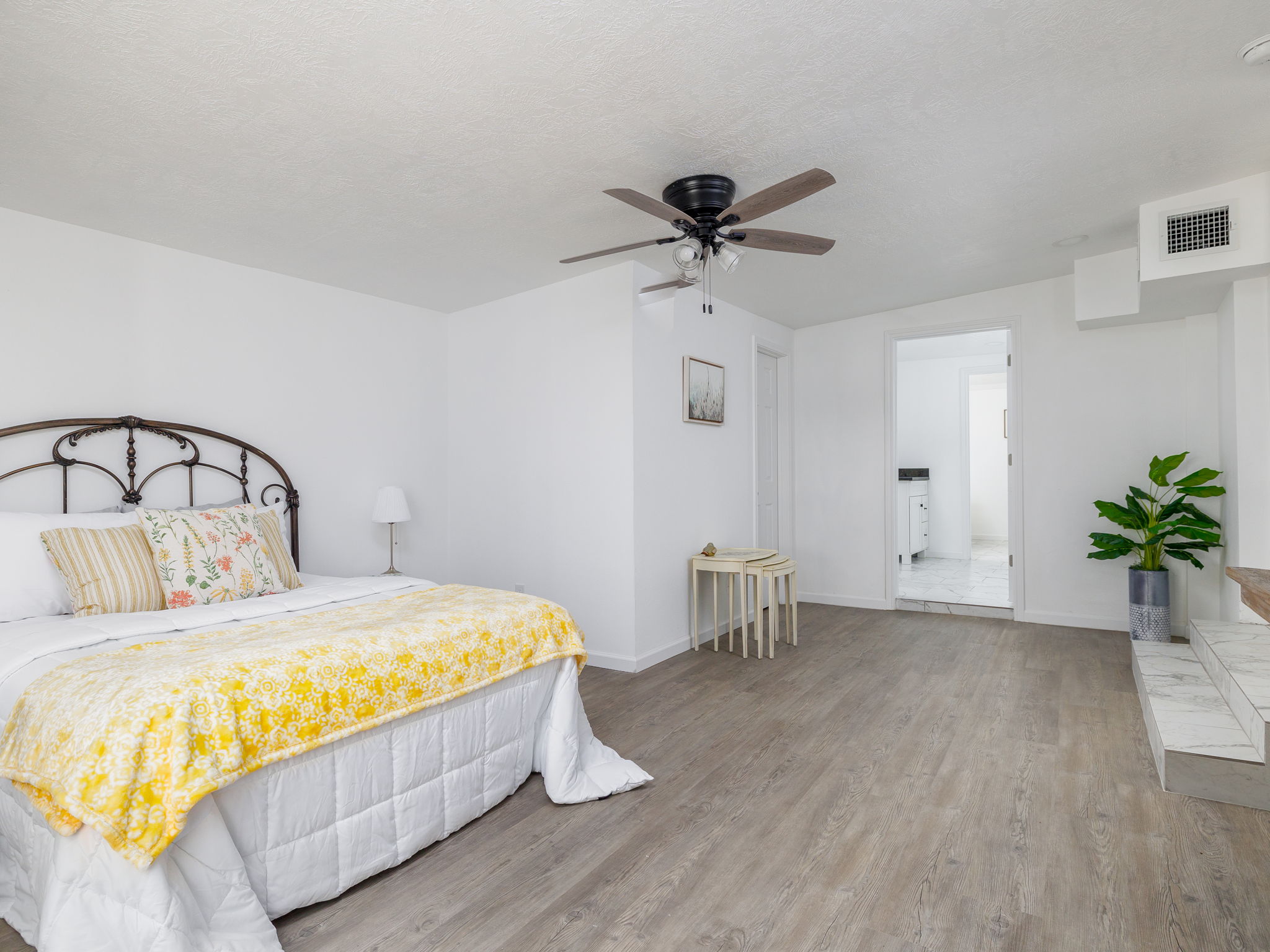 202 North Arendell Gause, TX 77857 - Photo 11 of 30 a bedroom with a bed and a chandelier