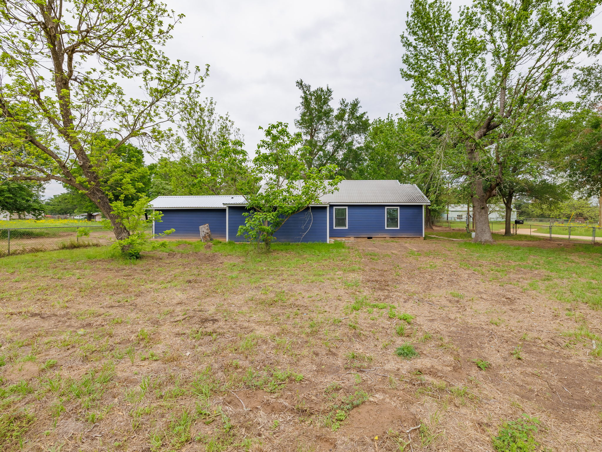 202 North Arendell Gause, TX 77857 - Photo 19 of 30 a front view of a house with a yard and trees