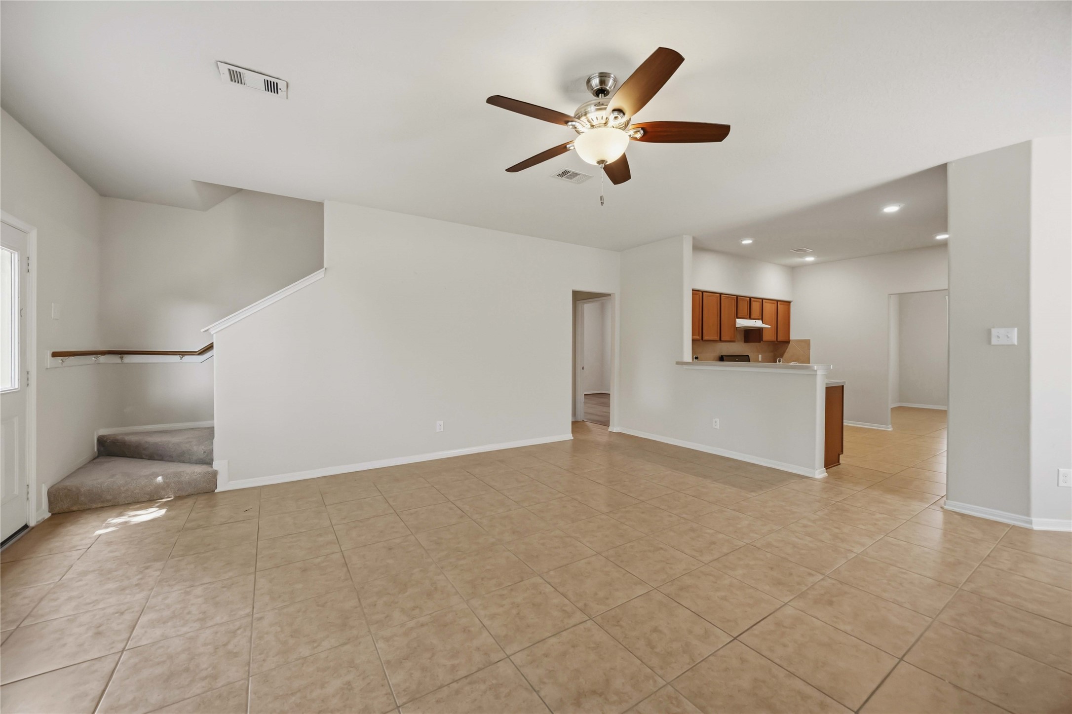 29526 Winton Wood Way Spring, TX 77386 - Photo 6 of 29 Open-concept layout connects the living room, dining area, kitchen, staircase, and first-floor primary suite for everyday living.