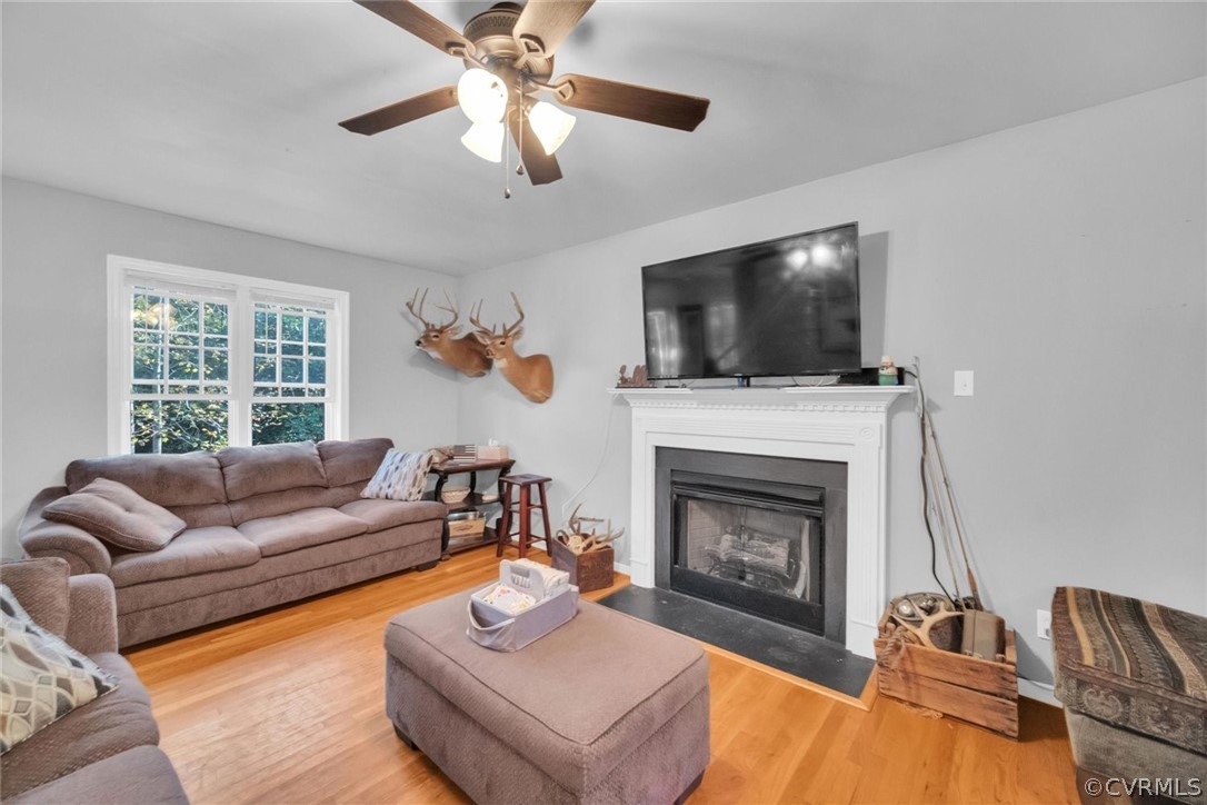11619 Corte Castle Road Chesterfield, VA 23838 - Photo 3 of 18 a living room with furniture a fireplace and a flat screen tv